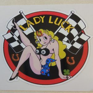 Lady Luck in yellow lettering on a black background with a red border. Centre is a blonde buxom pin up wearing a number 8 bikini top and heels. Crossed chequered flags, clover leaf and horseshoes surround her.