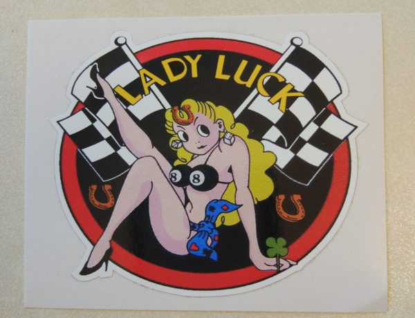 LADY LUCK STICKER. Lady Luck in yellow lettering on a black background with a red border. Centre is a blonde buxom pin up wearing a number 8 bikini top and heels. Crossed chequered flags, clover leaf and horseshoes surround her.