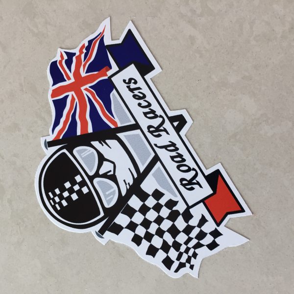 CHEQUERED UNION JACK ROAD RACERS STICKER. Road Racers in black lettering on a white banner. Behind are crossed chequered and Union Jack flags. The face of a motorcyclist wearing helmet, goggles and scarf sits between.