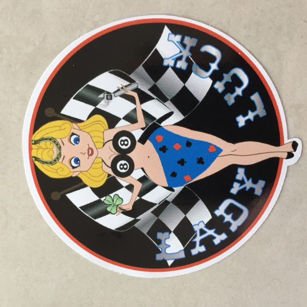 LADY LUCK STICKERS. Lady Luck in silver lettering on a black background. A blonde pin up wearing a number 8 bikini top and four aces sarong with a horseshoe in her hair. She stands in front of crossed chequered flags while holding a tool and a clover leaf.