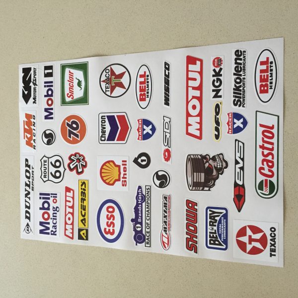 An assortment of stickers. Logos including Texaco, Castrol, Bell Helmets, Esso, Shell, Dunlop, Route 66 and more.