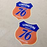 UNION 76 GASOLINE STICKERS. Union Product 76 Gasoline lettering on a blue and orange Route 66 shaped sticker.