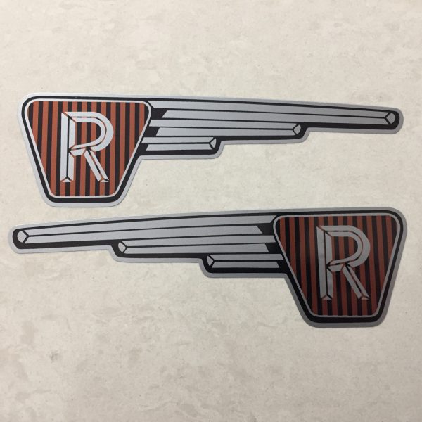 RALEIGH RUNABOUT FAIRING STICKERS. The letter R in silver on a black and brown vertical striped background inside an inverted triangle. A silver wing effect protrudes from one side.