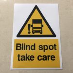 BLIND SPOT STICKER. A black and yellow hazard triangle featuring a lorry and an exclamation mark. Below in black lettering Blind spot take care within a yellow rectangle.