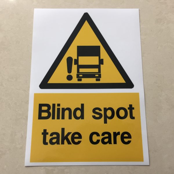 BLIND SPOT STICKER. A black and yellow hazard triangle featuring a lorry and an exclamation mark. Below in black lettering Blind spot take care within a yellow rectangle.