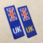 NUMBER PLATE ORIGIN STICKERS DOMED RESIN GEL UK. Two blue columns. UK in white at the base of one column. UK in yellow on the other. Both stickers have the Union Jack at the top.