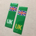 NUMBER PLATE ORIGIN EV STICKERS DOMED RESIN GEL UK. Two green columns. UK in white at the base of one column. UK in yellow on the other. Both stickers have the Union Jack at the top.
