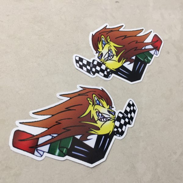 APRILIA LIONHEAD ITALIAN FLAG AND CHEQUERS STICKERS. A lions head sits between a black and white chequered flag and the Italian flag.