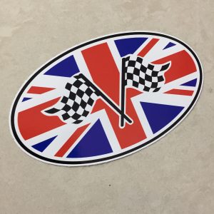 UNION JACK CHEQUERED OVAL STICKER. Two crossed black and white chequered flags overlay an oval Union Jack.