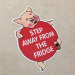 STEP AWAY FROM THE FRIDGE STICKER. A humorous piggy. Step Away From The Fridge in white lettering on it's round red body.