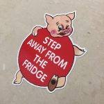 STEP AWAY FROM THE FRIDGE STICKER. A humorous piggy. Step Away From The Fridge in white lettering on it's round red body.