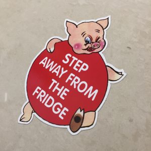 STEP AWAY FROM THE FRIDGE STICKER. A humorous piggy. Step Away From The Fridge in white lettering on it's round red body.