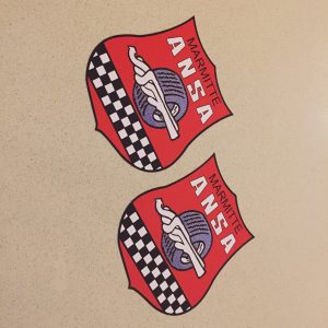 ANSA MARMITTE EXHAUSTS STICKERS. Marmitte in black Ansa in white uppercase lettering on a red shield shaped sticker. Additional images of a tyre, an exhaust and black and white chequer.