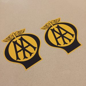 AA OLD STYLE STICKERS AA in black lettering on a yellow circle within a black balloon shaped sticker. A pair of wings sit on the top.