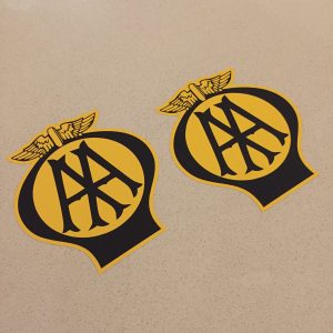 AA OLD STYLE STICKERS. AA in black lettering on a yellow circle within a black balloon shaped sticker. A pair of wings sit on the top.