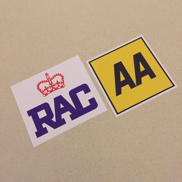 AA AND RAC STICKERS. AA in black lettering on a yellow square. RAC in blue lettering with a red crown above on a white sticker.