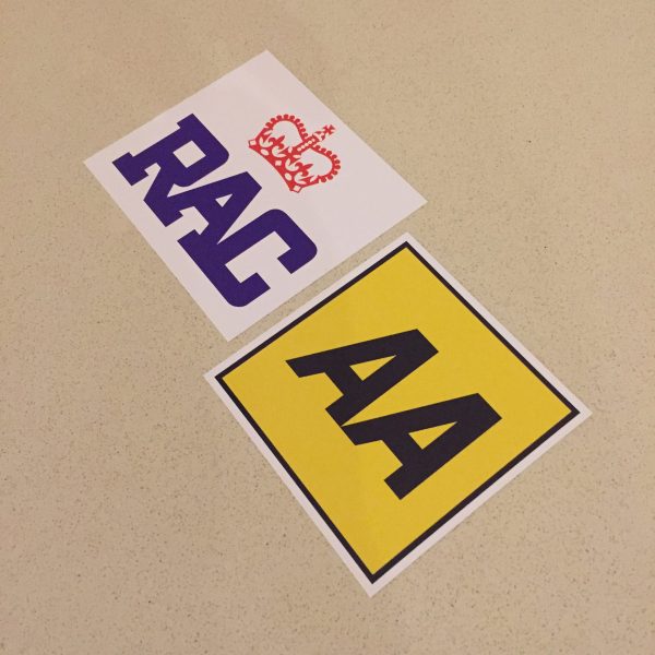AA AND RAC STICKERS. AA in black lettering on a yellow square. RAC in blue lettering with a red crown above on a white sticker.