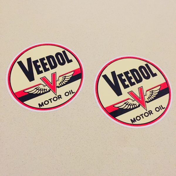 VEEDOL MOTOR OIL STICKERS. Veedol Motor Oil in black lettering on a circular sticker. The letter V in red overlays a pair of wings and two horizontal bands in red and black.