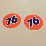 76 UNION RACE CAR STICKERS The number 76 in blue in the centre of an orange circular sticker.