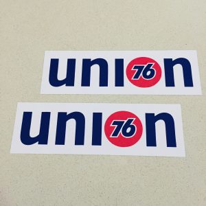 Union 76 on a white rectangular sticker. The letters u, n and i are blue and lowercase. The letter o is replaced with the 76 logo - the number 76 in blue in the centre of a red orange ball.