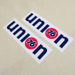 Union 76 on a white rectangular sticker. The letters u, n and i are blue and lowercase. The letter o is replaced with the 76 logo - the number 76 in blue in the centre of a red orange ball.