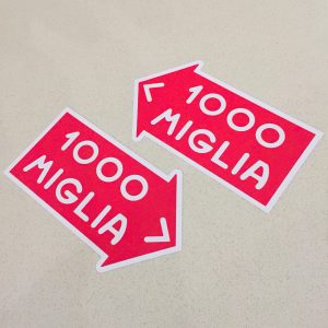 MILLE MIGLIA 1000 STICKERS. 1000 Miglia in white lettering on a red direction of travel arrow with a white border.