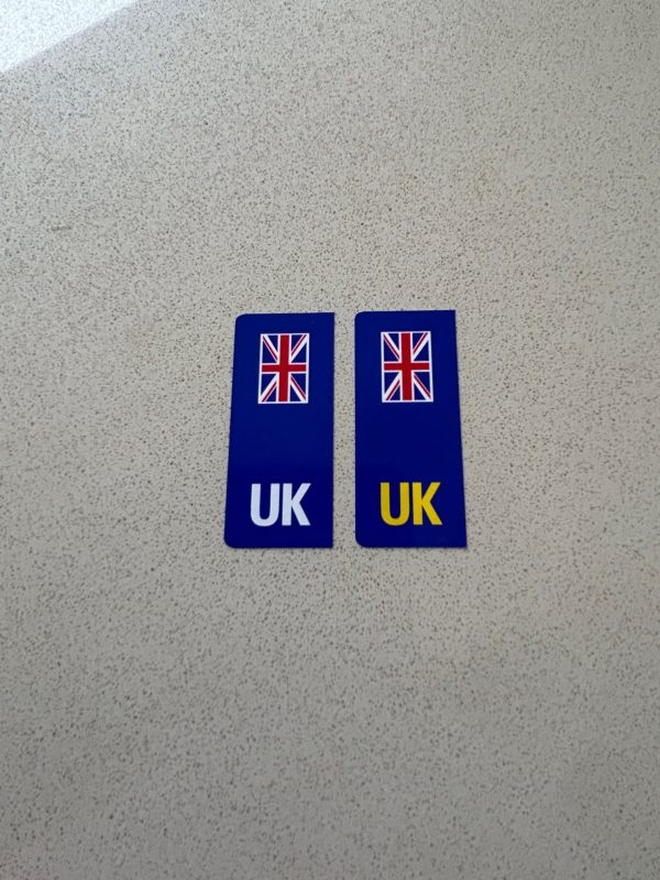 UK NUMBER PLATE STICKERS FOR MOTORBIKES. Two blue columns. UK in white at the base of one column and UK in yellow on the other. A vertical Union Jack sits at the top of each column.
