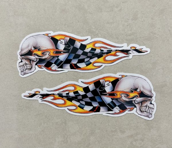 SKULL AND CHEQUERED FLAMES STICKERS. A skull trailing flames and a black and white chequered flag behind.