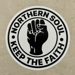 NORTHERN SOUL STICKER. Northern Soul Keep The Faith in black lettering surrounds a white circular sticker with a clenched black fist in the centre.