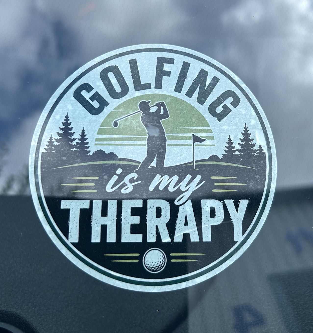 Golfer taking a shot, surrounded by trees